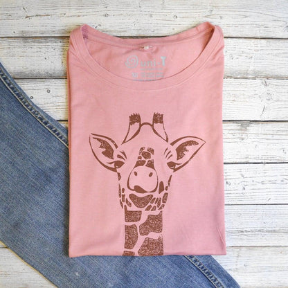 Folded pink Women's Giraffe T-Shirt made from bamboo and organic cotton. Features a brown safari animal print, perfect eco gift for her.