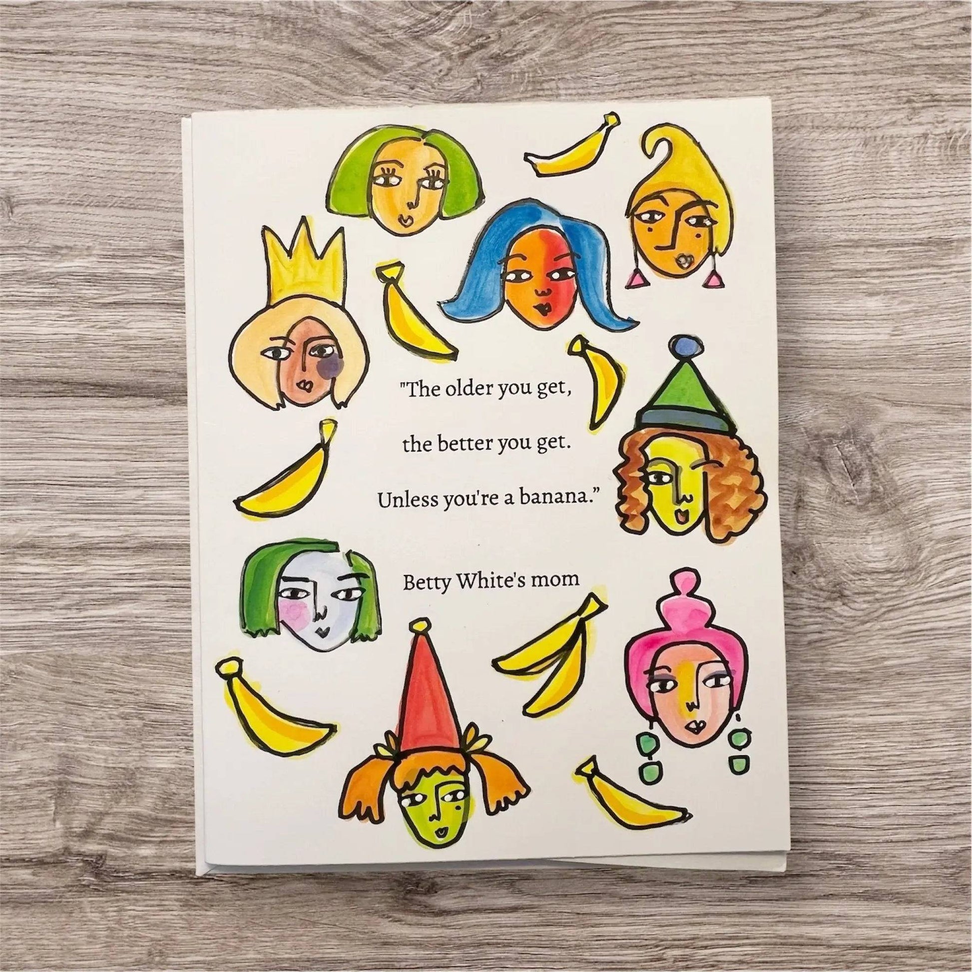 Inspirational Handmade Girl Power Card featuring colorful female faces and bananas with a humorous quote by 'Betty White's mom' about aging.