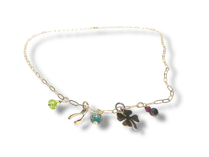 Gold charm necklace with colorful beads and clover pendant