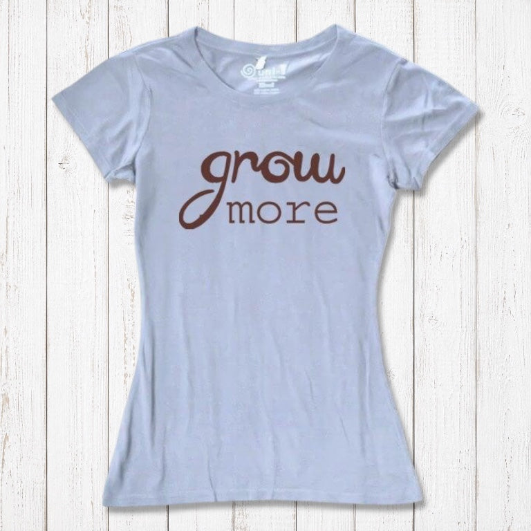 Light blue women's T-shirt with brown 'Grow More' text. Soft bamboo and organic cotton blend, ideal for plant and garden enthusiasts.