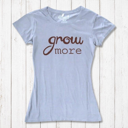 Light blue women's T-shirt with brown 'Grow More' text. Soft bamboo and organic cotton blend, ideal for plant and garden enthusiasts.