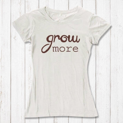 Cream-colored women's T-shirt with brown 'Grow More' typography. Eco-friendly bamboo and organic cotton tee for gardening lovers.
