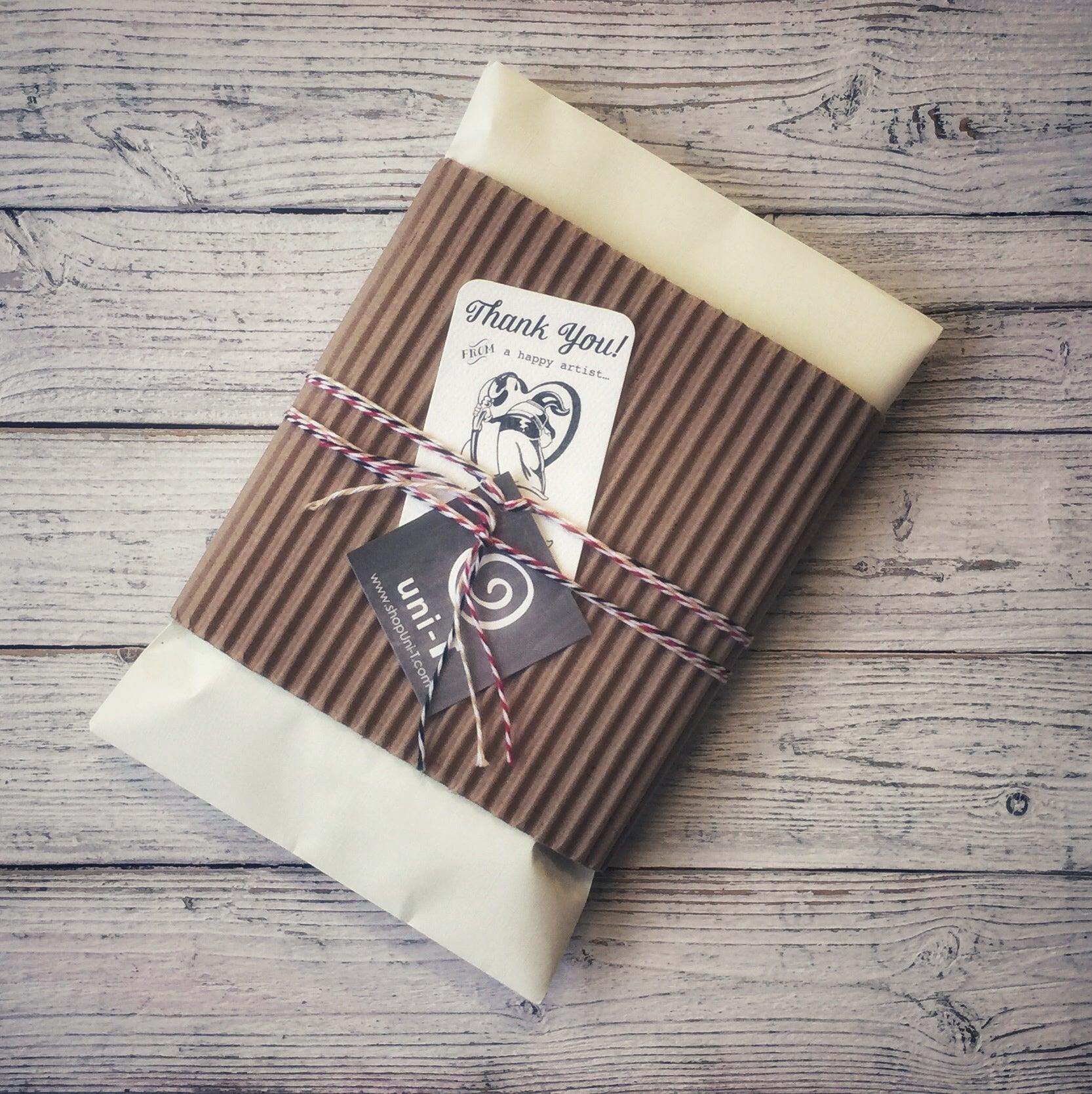 Eco-conscious gift packaging with thank you tag and twine, used for shipping 'Grow More' bamboo long sleeve T-shirts for men.