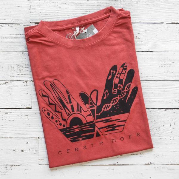 Folded red Men's Hand Art T-Shirt in Bamboo & Organic Cotton with black 'Create More' graphic. Eco-friendly gift for artistic creators.