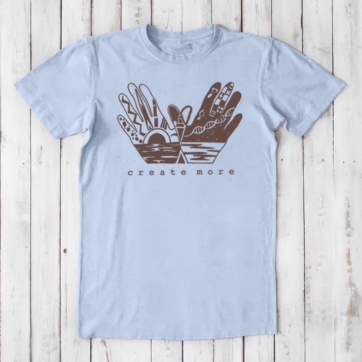 Light blue Men's Hand Art T-Shirt in Bamboo & Organic Cotton with brown 'Create More' graphic. Soft, sustainable shirt for artists.