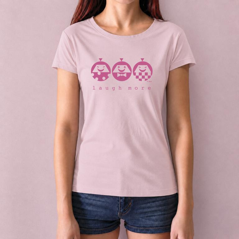 Pink Women's Bamboo & Organic Cotton T-Shirt with white 'Laugh More' graphic. Funny inspirational gift tee with happy cartoon characters.