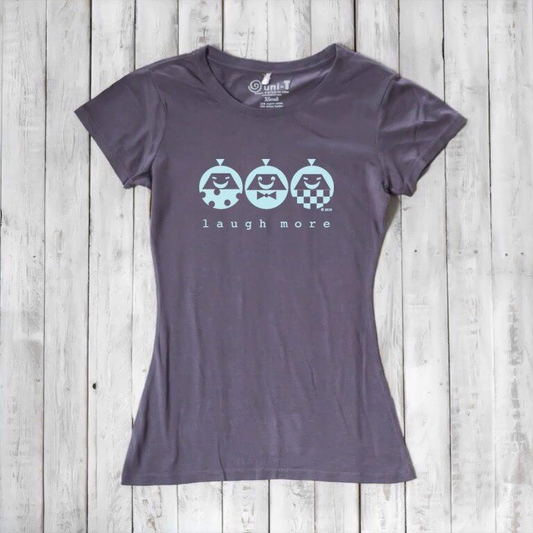 Charcoal gray Women's Organic Cotton T-Shirt with light blue 'Laugh More' print. Eco-conscious and uplifting graphic tee.