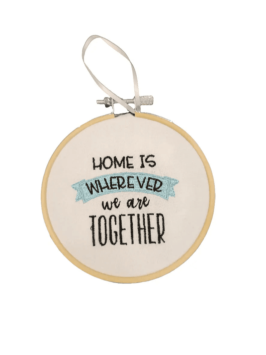 Elegant embroidered ornament for home decor featuring heartfelt quote in wooden hoop, ideal for holiday or everyday space decoration.