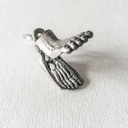Anatomical Human Foot Keychain opened to reveal detailed skeletal structure. Unique accessory for medical or anatomy enthusiasts.
