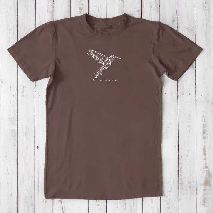 Men's Hummingbird T-Shirt in Bamboo & Organic Cotton, chocolate brown with white hummingbird line art and 'hum more' text, nature-inspired.