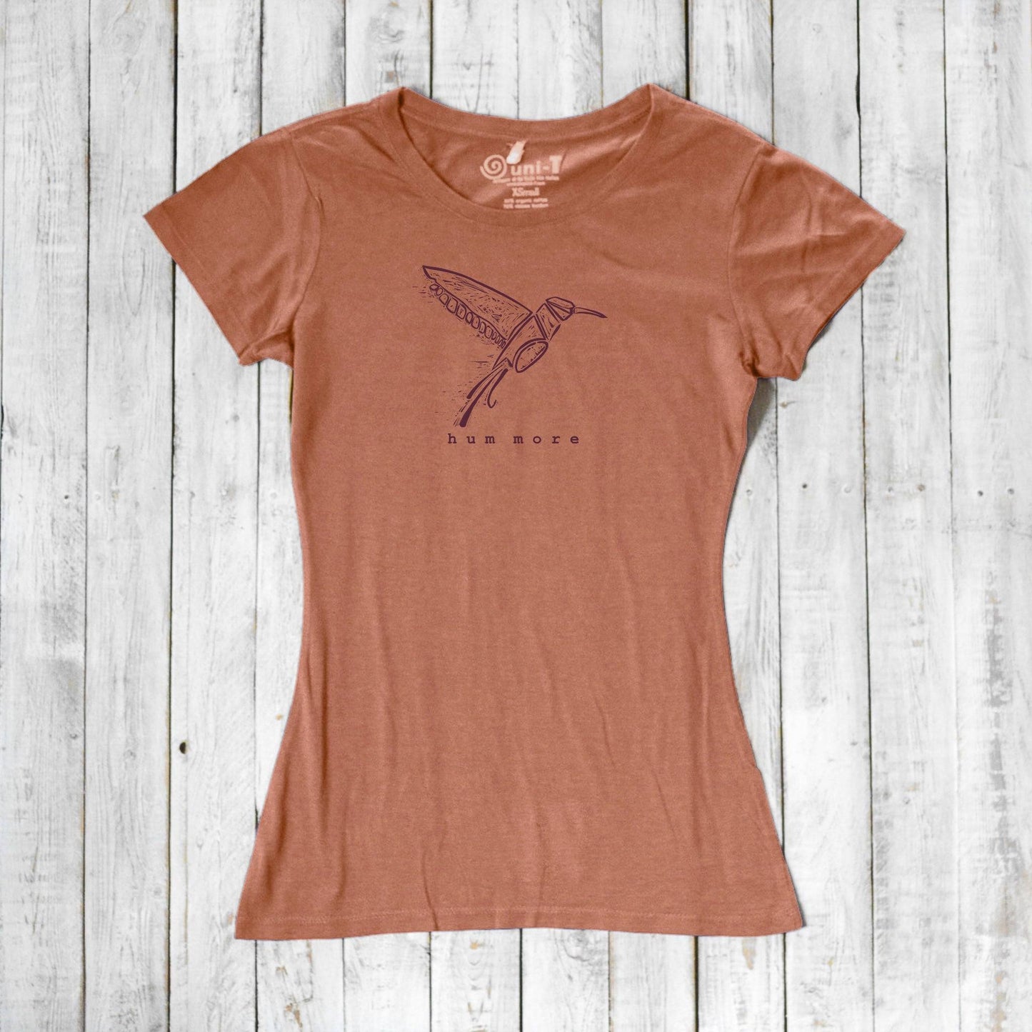 Rust-colored Hum More Women's Bamboo Hummingbird Shirt featuring a minimalist hummingbird print on eco-friendly bamboo and cotton fabric.