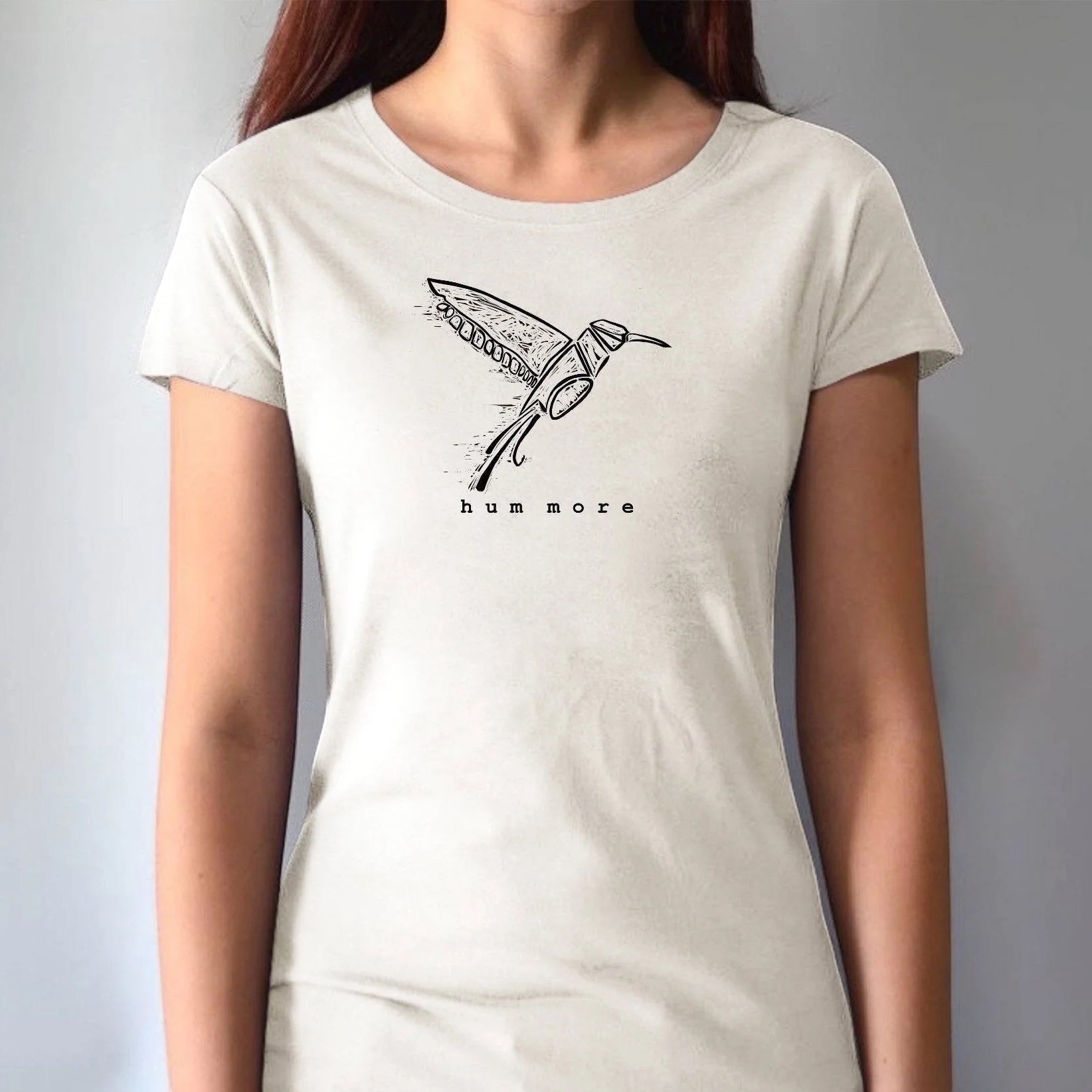 Hum More Women's Bamboo Hummingbird Shirt in natural white, featuring minimalist hummingbird line art and eco-friendly fabric blend.