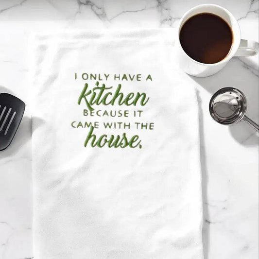 Embroidered kitchen towel made from soft, absorbent flour sack material with humorous quote, ideal for drying dishes or gifting friends.