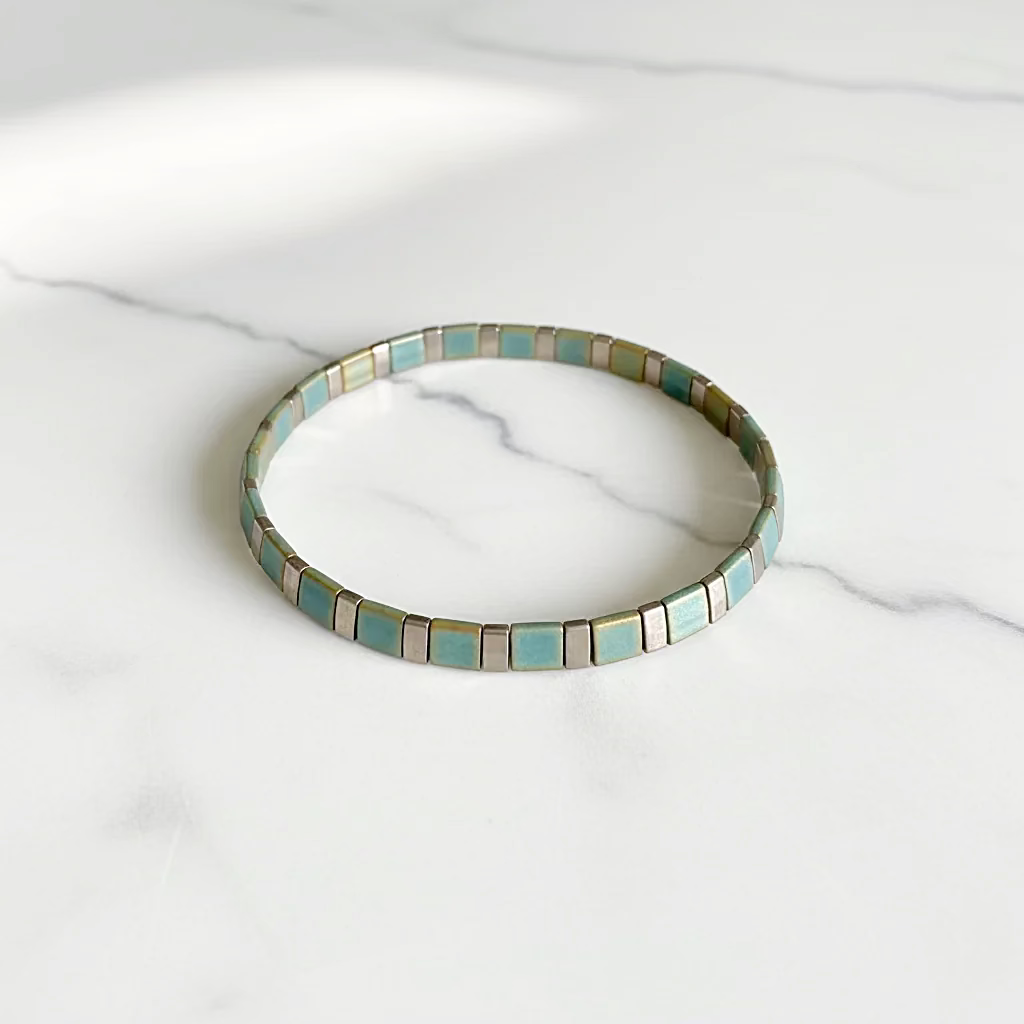 Flat Tile Bead Stretch Bracelet on white marble surface