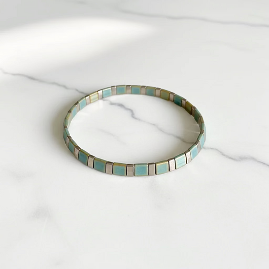 Flat Tile Bead Stretch Bracelet on white marble surface