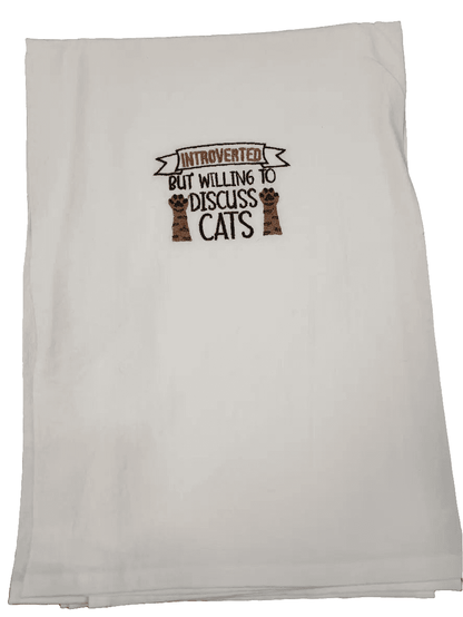 Folded embroidered kitchen towel featuring cat paw design and humorous quote, ideal for introverted cat lovers seeking fun kitchen linens.