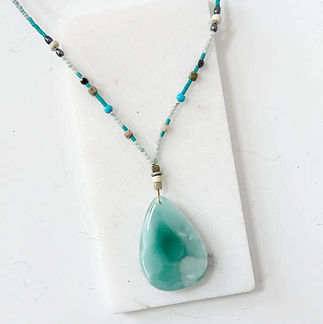 Iridescent teardrop dark green moonstone necklace featuring turquoise and silver accents, 18-inch length with elegant silver clasp.