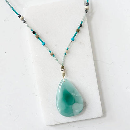 Iridescent teardrop dark green moonstone necklace featuring turquoise and silver accents, 18-inch length with elegant silver clasp.