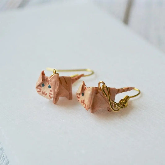 Close-up of orange-tabby Origami Cat Earrings made from paper and acrylic sealant, showcasing detailed cat faces and gold hook design.