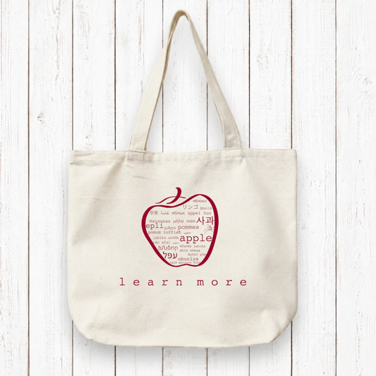 Teachers Gift Organic Canvas Tote with red apple word art and 'learn more' text. Eco-friendly bag ideal for educators and book lovers.