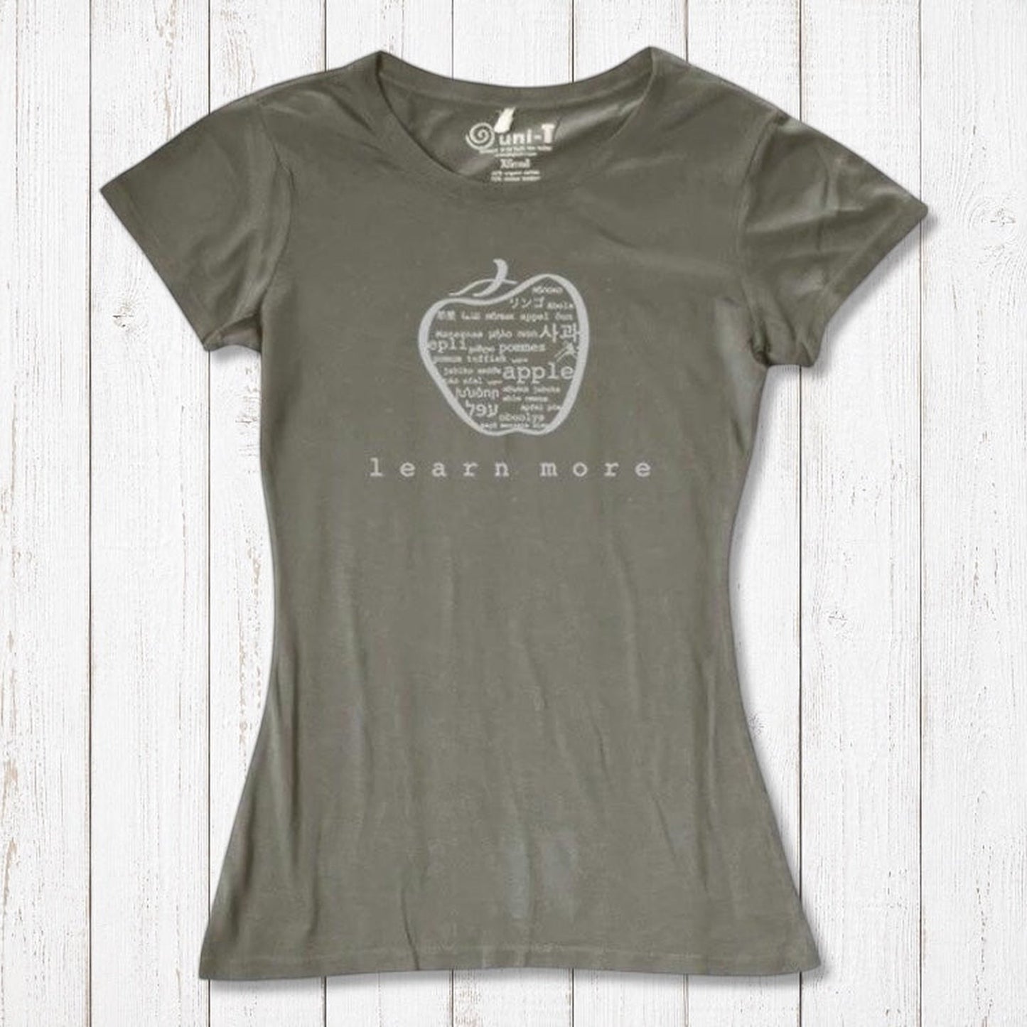 Olive green women's bamboo & organic cotton apple graphic tee with 'learn more' text, perfect sustainable gift for educators.