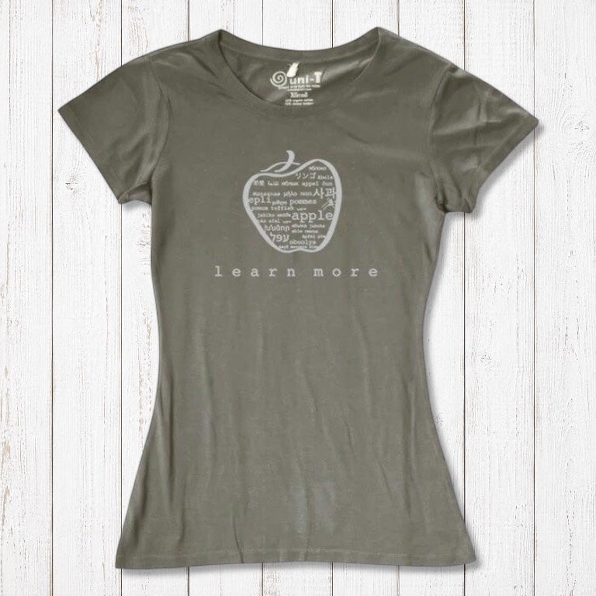 Olive green women's bamboo & organic cotton apple graphic tee with 'learn more' text, perfect sustainable gift for educators.