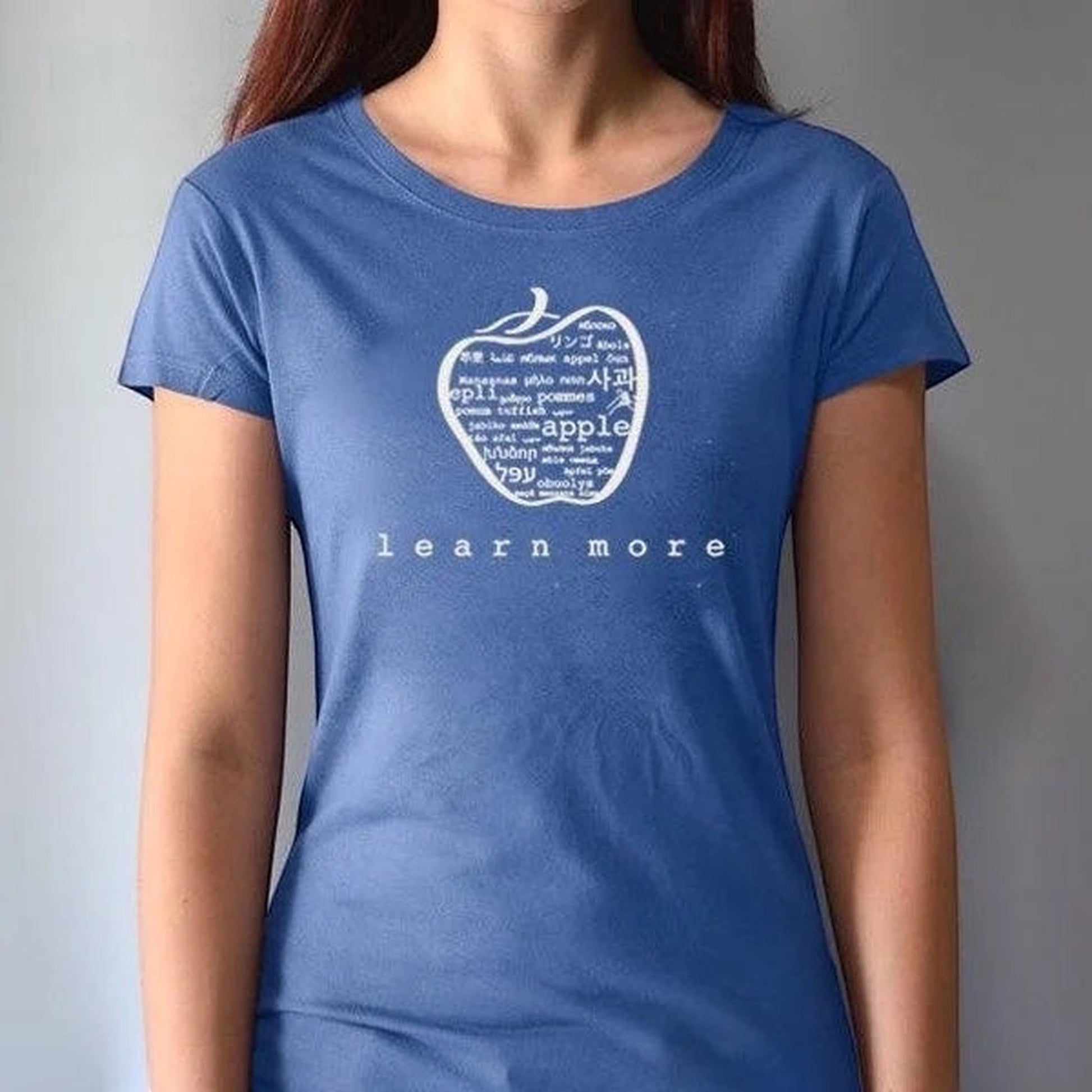 Blue fitted women's apple T-shirt made from bamboo & organic cotton, featuring 'learn more' graphic, great for teachers and learners.