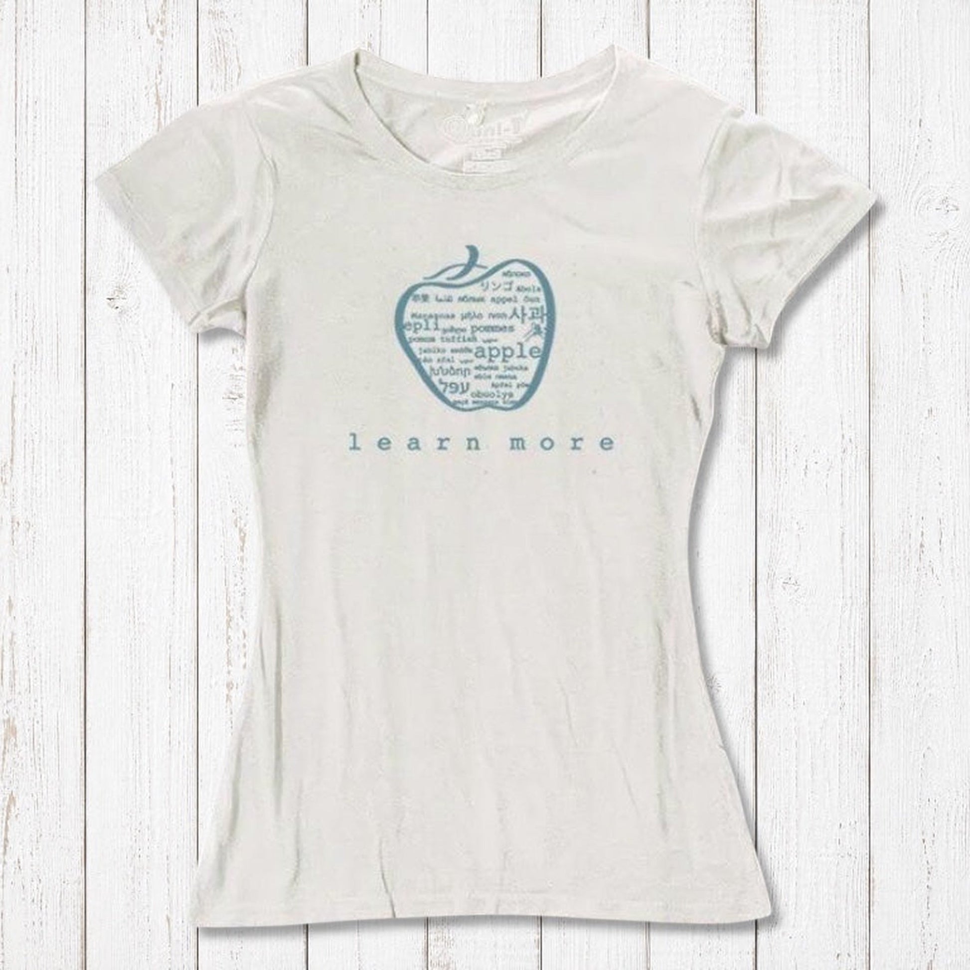 White women's apple graphic T-shirt in bamboo & organic cotton with 'learn more' text, sustainable and stylish teacher gift.