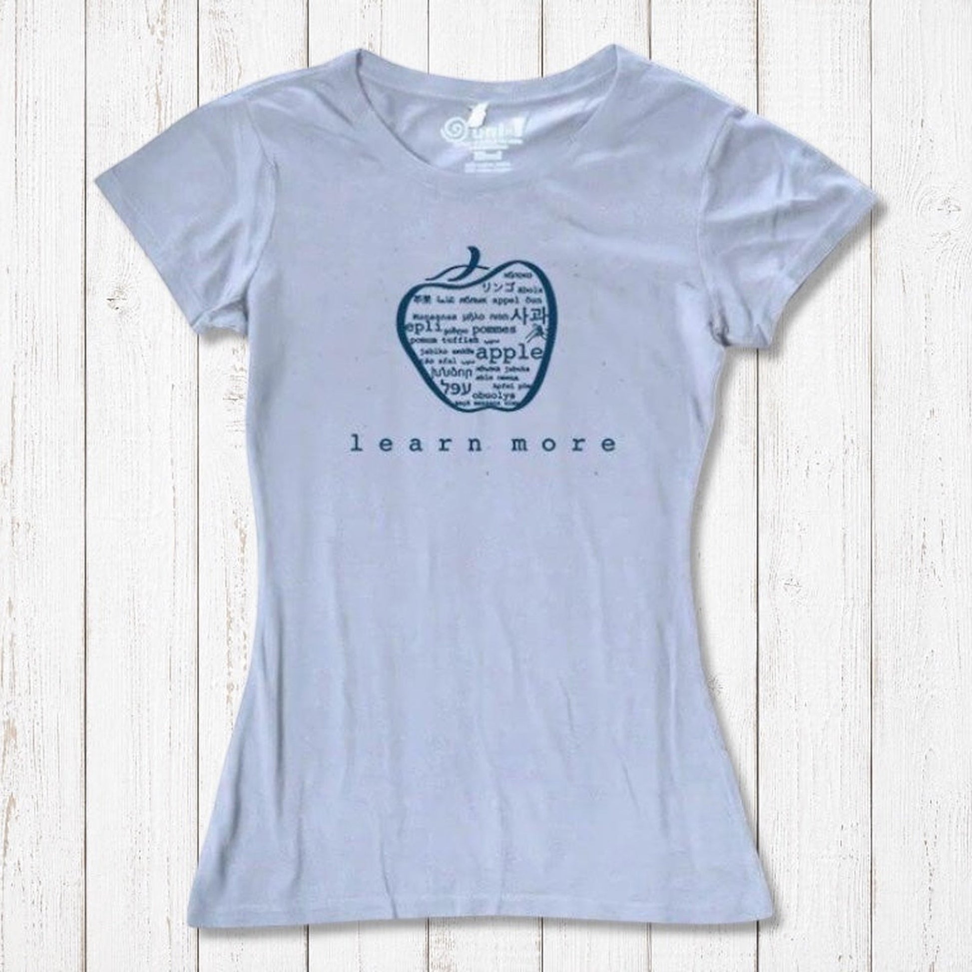 Light blue women's T-shirt made from bamboo & organic cotton, featuring apple 'learn more' graphic, perfect for teacher gifts.