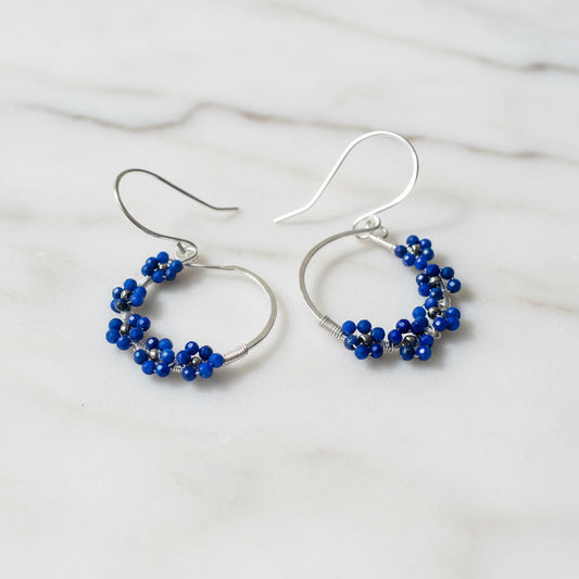 Sterling silver hoop earrings with blue lapis lazuli flower accents, handcrafted jewelry