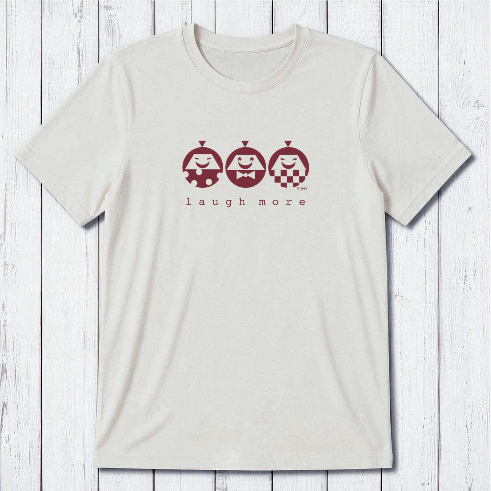 Men's Happy T-Shirt in Bamboo & Organic Cotton with 'Laugh More' quote and cartoon faces in maroon on cream. Eco-friendly funny gift tee.