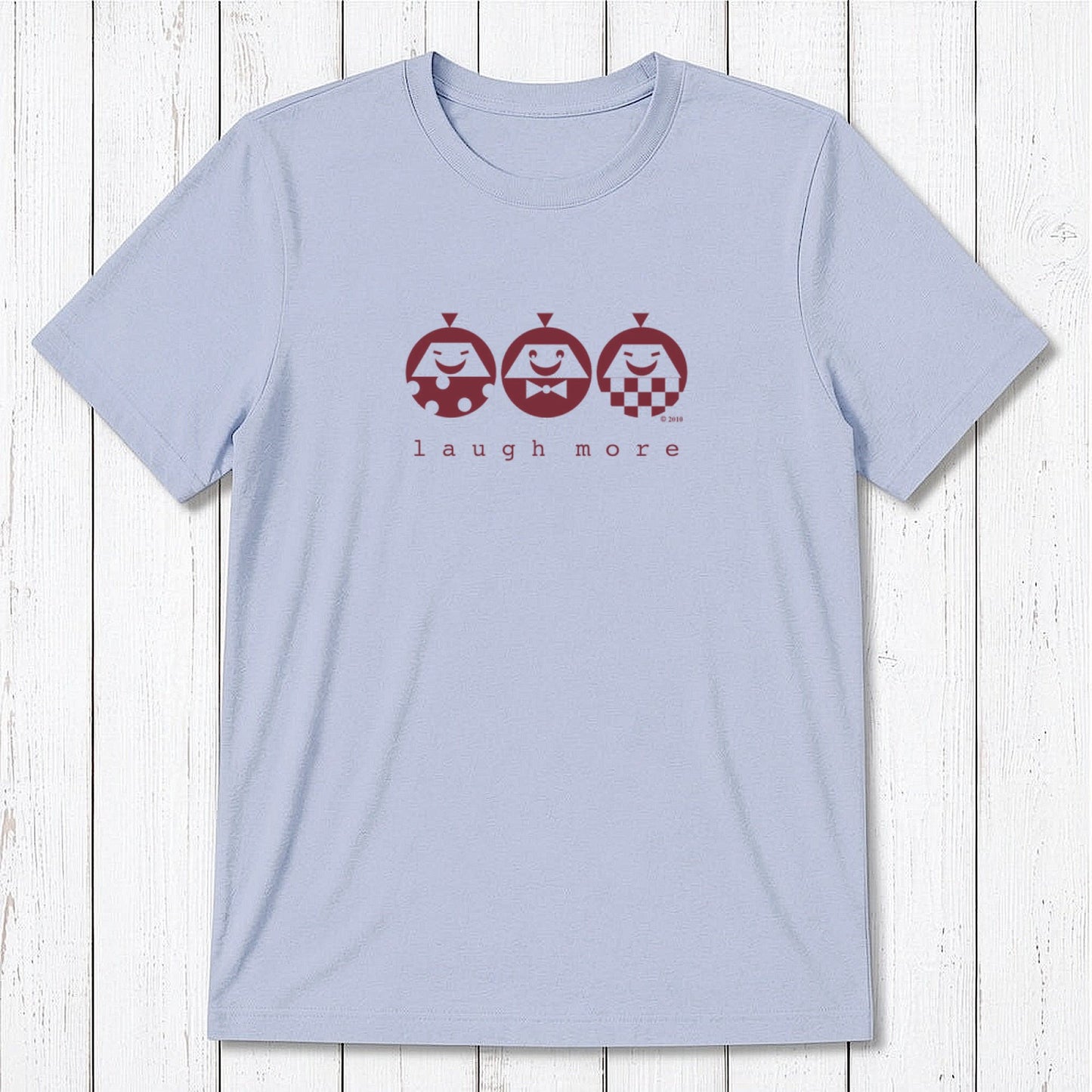 Men's Happy T-Shirt in Bamboo & Organic Cotton in light blue featuring maroon 'Laugh More' quote and cartoon faces. Uplifting eco-friendly gift.