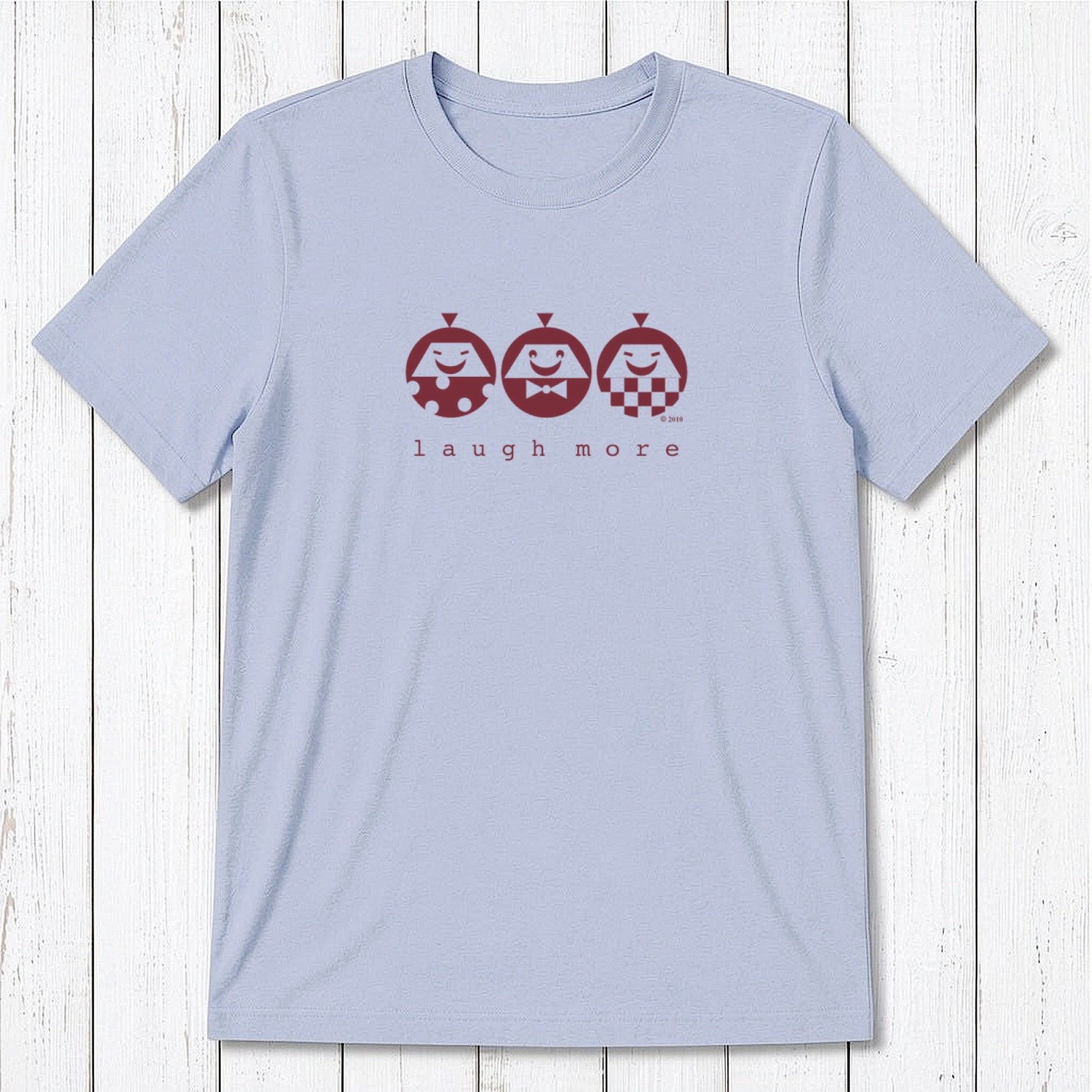 Men's Happy T-Shirt in Bamboo & Organic Cotton in light blue featuring maroon 'Laugh More' quote and cartoon faces. Uplifting eco-friendly gift.