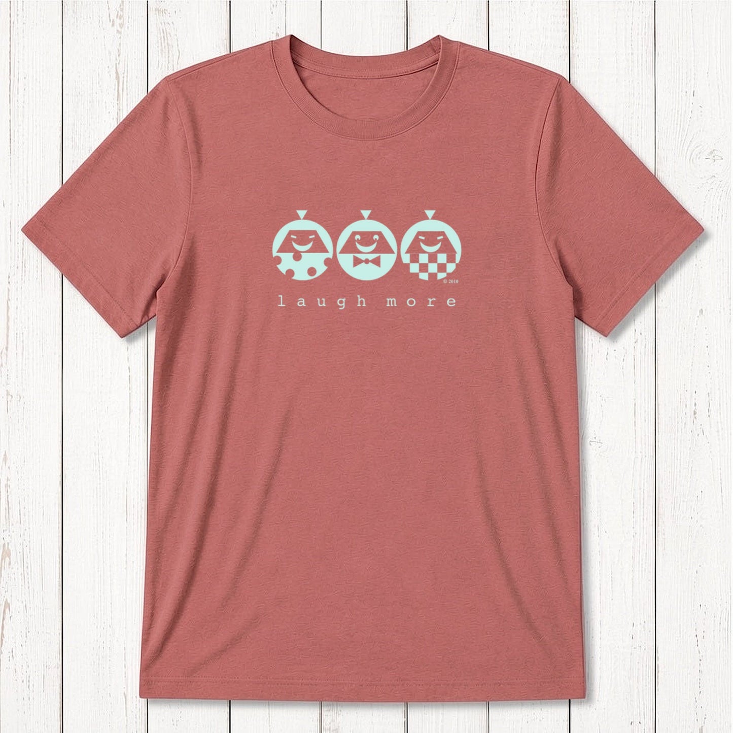 Men's Happy T-Shirt in Bamboo & Organic Cotton in faded red with mint 'Laugh More' graphic. Sustainable and cheerful gift idea.