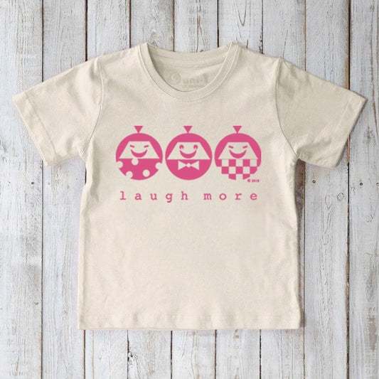 Kids' Happy Vibe Organic Cotton T-Shirt in cream with pink 'Laugh More' graphic. Sustainable cute graphic tee by Uni-T for children.