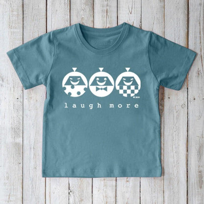 Teal blue Kids' Happy Vibe Organic Cotton T-Shirt with white 'Laugh More' design. Sustainable and fun graphic tee for children.