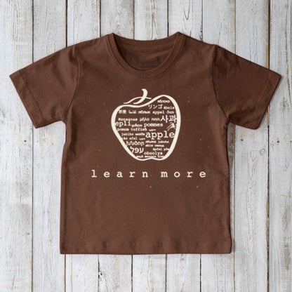 Brown Kids' Apple Organic Cotton T-Shirt featuring white apple word art and 'learn more' slogan. Eco-conscious graphic tee for kids by Uni-T.