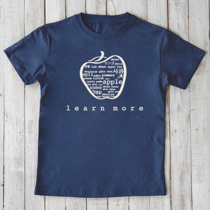 Navy Kids' Apple Organic Cotton T-Shirt with white apple graphic and 'learn more' slogan. Sustainable educational shirt for children by Uni-T.