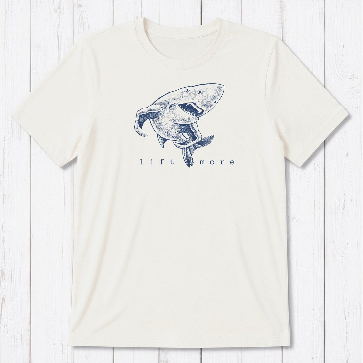 White men's graphic t-shirt with shark and 'Lift More' text, made from eco-friendly bamboo and organic cotton blend.