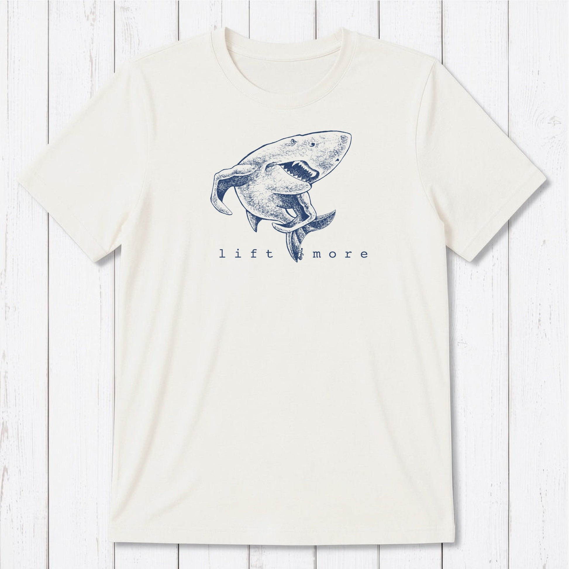 White men's graphic t-shirt with shark and 'Lift More' text, made from eco-friendly bamboo and organic cotton blend.
