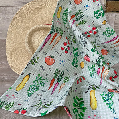 Vegetable print cotton-linen kitchen towel on woven placemat