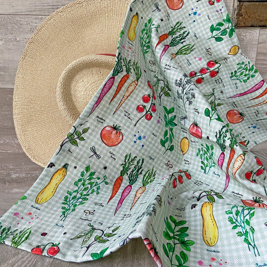 Vegetable print cotton-linen kitchen towel on woven placemat
