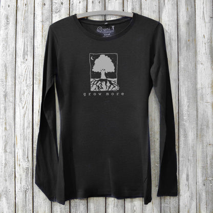 Black sustainable women's long sleeve T-shirt with nature-inspired 'Grow More' tree print, ideal gift for plant lovers and gardening enthusiasts.