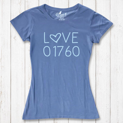 Blue women's T-shirt made of organic cotton and bamboo with 'LOVE' and '01760' printed in light blue, casual wear on white wooden background