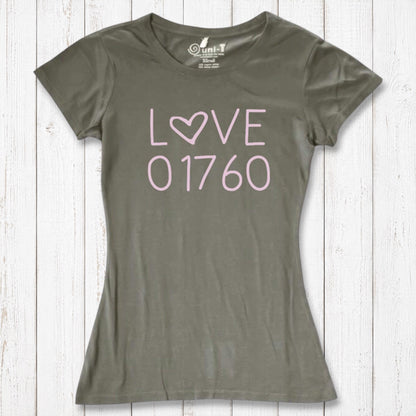 Olive green women's T-shirt with pink 'LOVE' text and heart symbol, made of organic cotton and bamboo, casual fit, on white wooden background