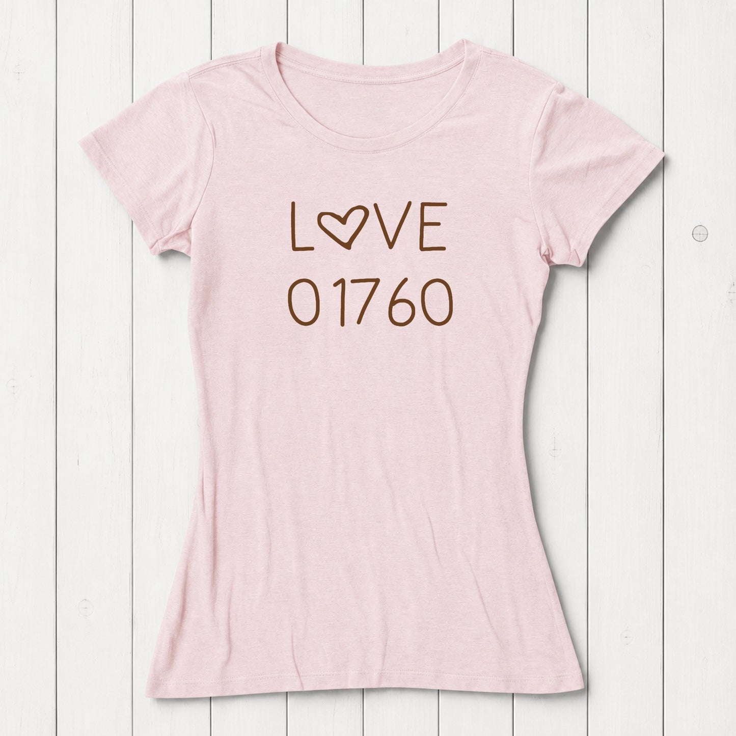 Pink women's T-shirt made of bamboo and organic cotton with 'LOVE' text and heart symbol, laid flat on white wooden background, SKU: WSSXXSPUR