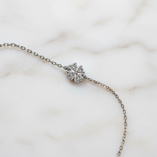 Close-up of silver chain bracelet with butterfly detail
