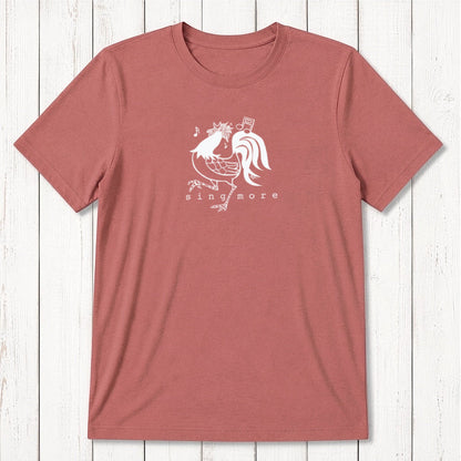 Rust red men's 'Sing More' rooster t-shirt in bamboo and organic cotton, featuring a light-colored humorous farm animal print.