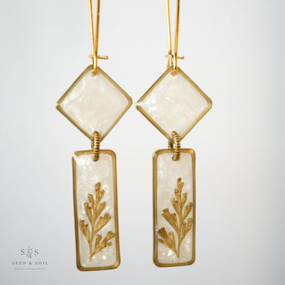 Close-up of Midas Art Deco Dangle Earrings showcasing vintage-inspired brass frames, gold plating, and botanical fern design.
