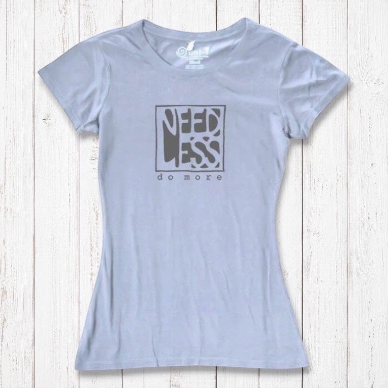 Light lavender women's bamboo and organic cotton t-shirt with 'Need Less Do More' quote. Sustainable minimalist fashion gift.